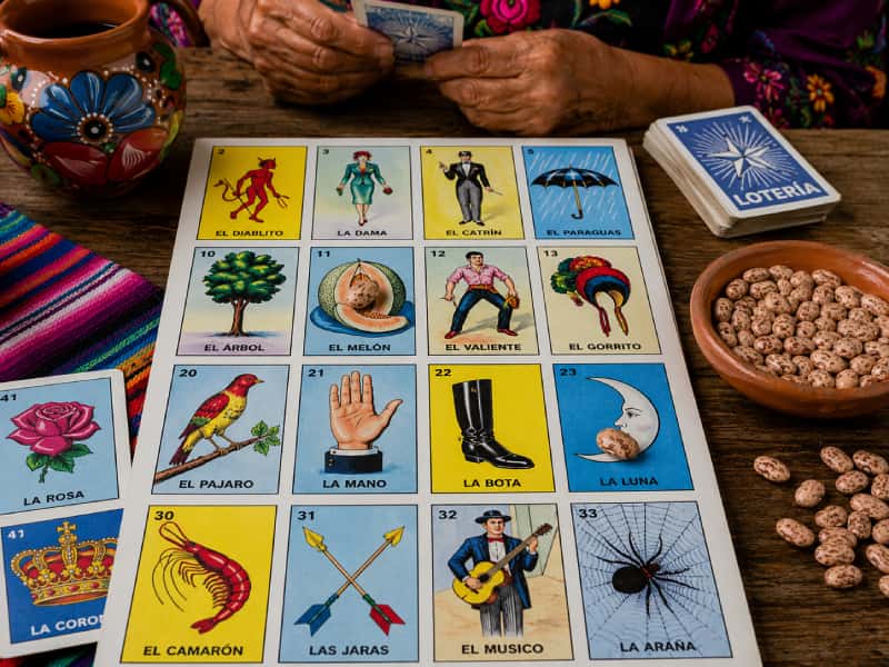 A traditional Lotería board, cards, and dried beans ready for play